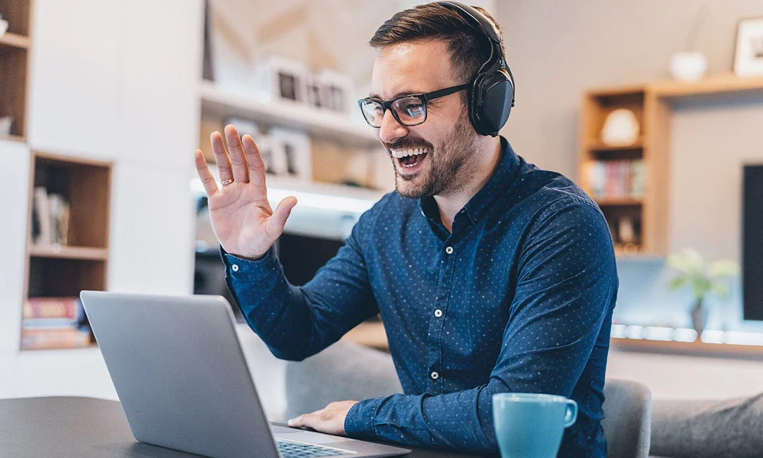 Trainer smiling during a virtual classroom video call.